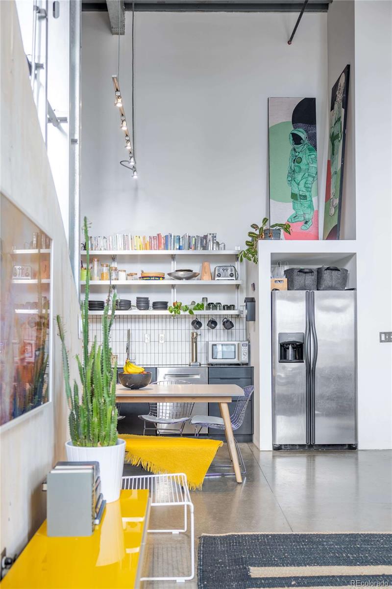 3457 Ringsby Court, Unit 306 Denver, CO 80216 - Photo 11 of 38 a living room with fireplace furniture and a large window