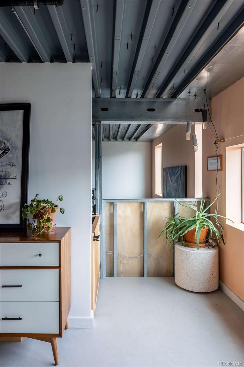 3457 Ringsby Court, Unit 306 Denver, CO 80216 - Photo 22 of 38 a living room with furniture and a potted plant