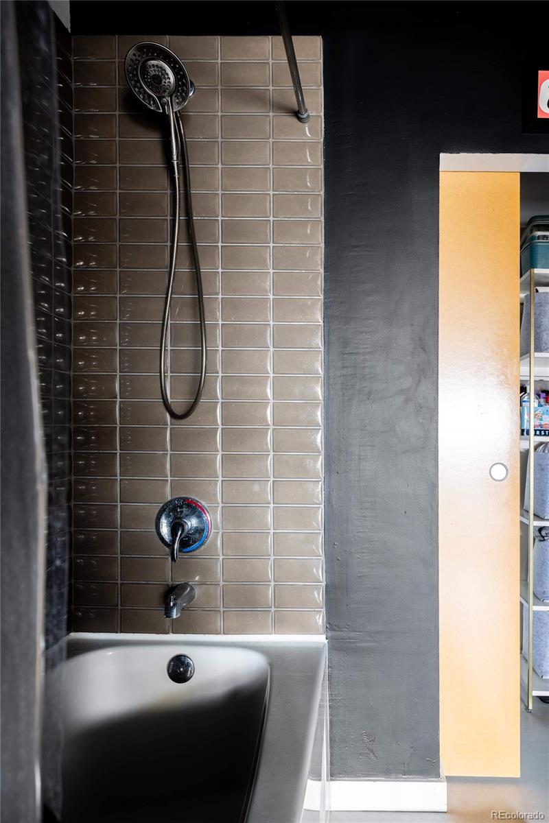 3457 Ringsby Court, Unit 306 Denver, CO 80216 - Photo 27 of 38 a bathroom with a shower