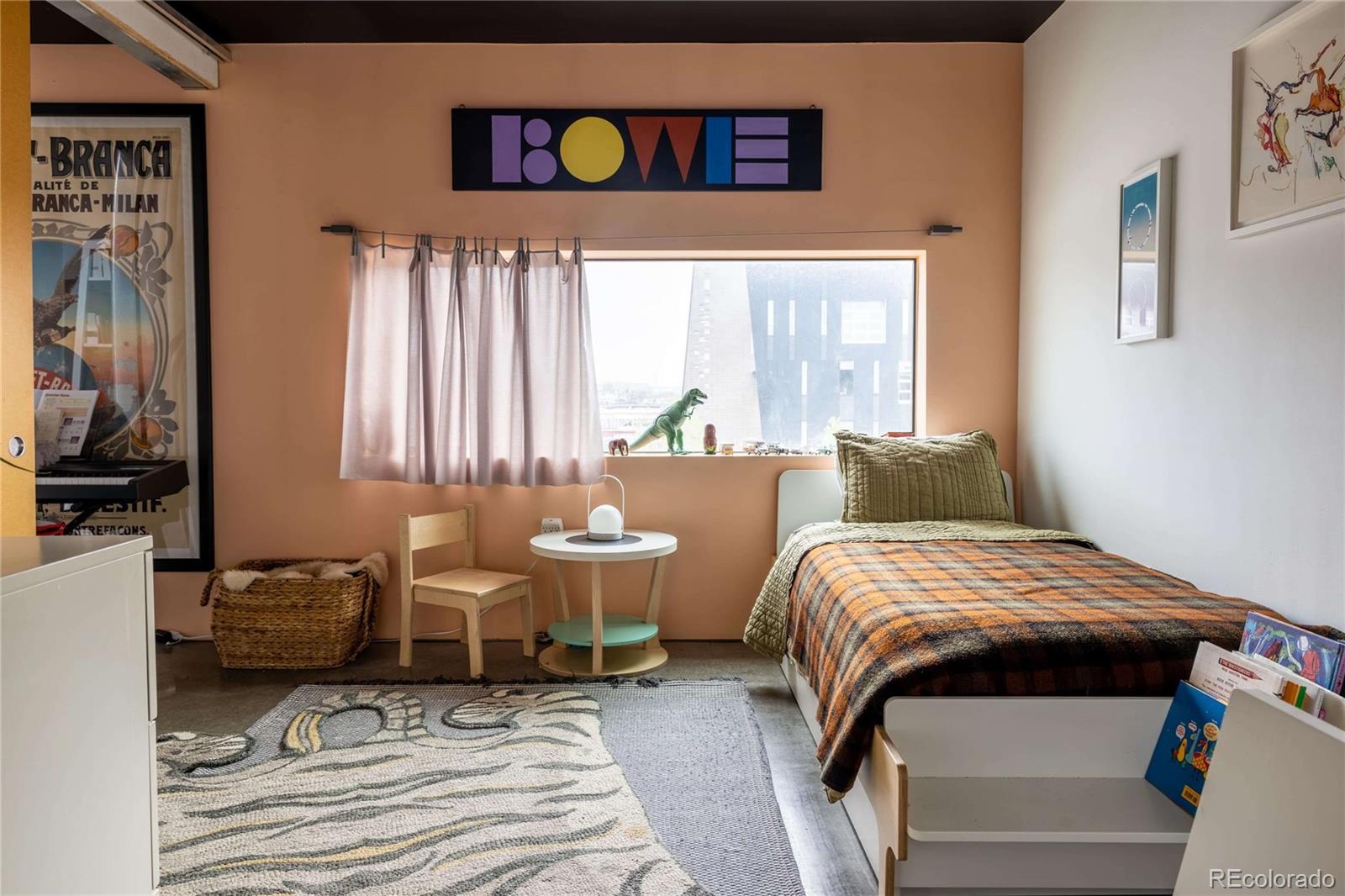 3457 Ringsby Court, Unit 306 Denver, CO 80216 - Photo 28 of 38 a bedroom with bed and a window