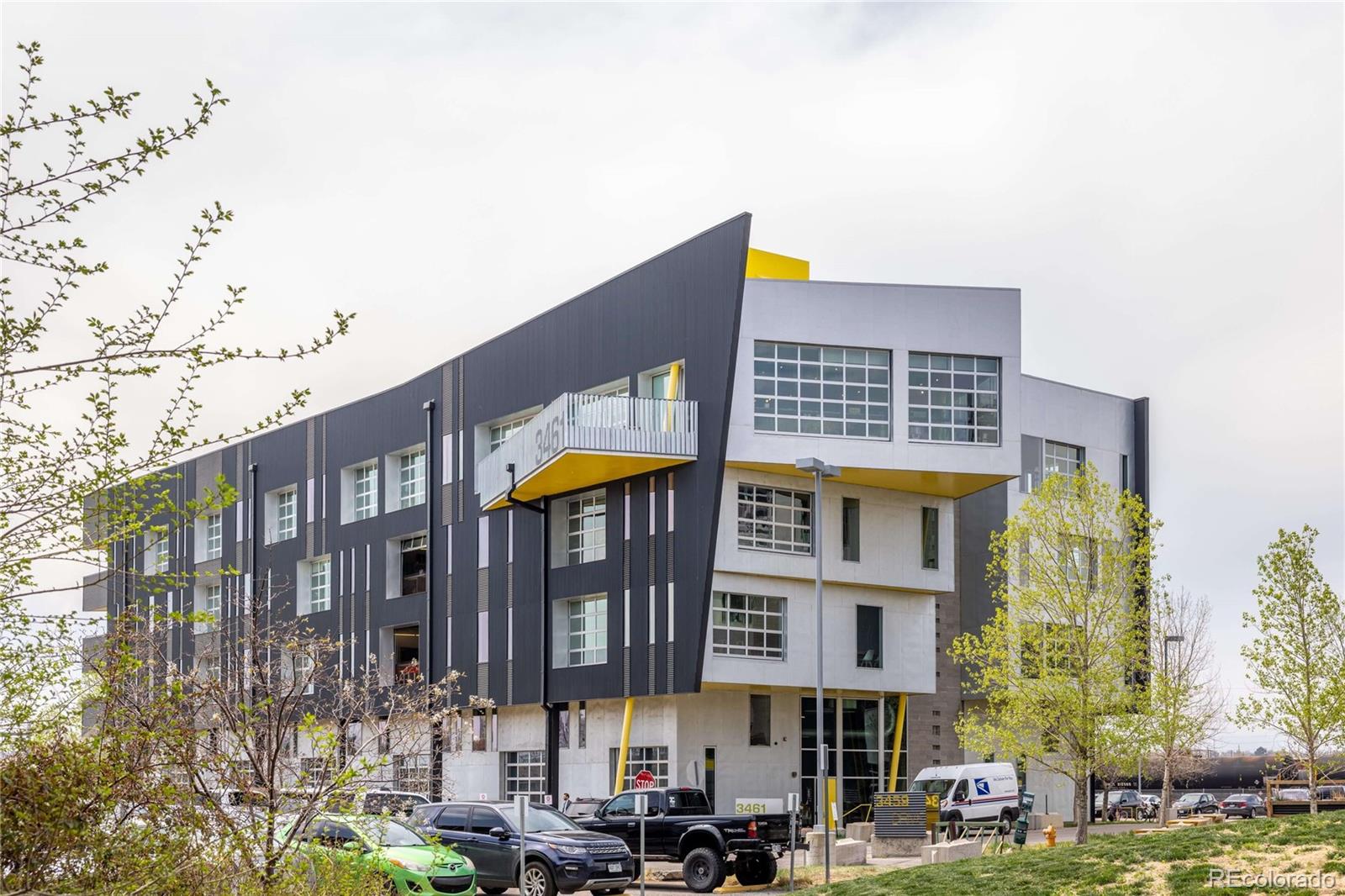 3457 Ringsby Court, Unit 306 Denver, CO 80216 - Photo 36 of 38 a front view of a building with street view