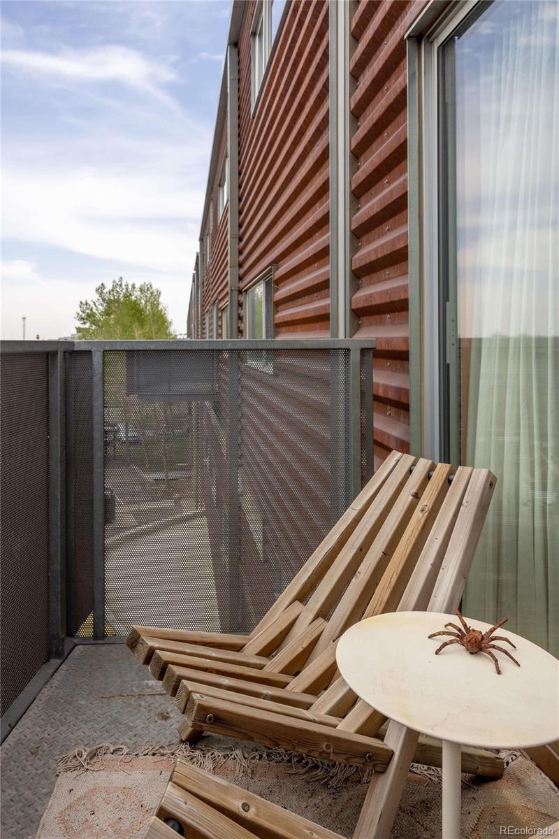 3457 Ringsby Court, Unit 306 Denver, CO 80216 - Photo 9 of 38 a backyard of a house with table and chairs