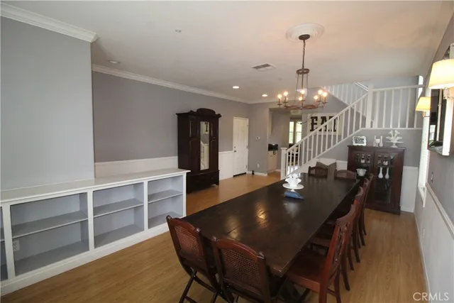 a kitchen with a dining table chairs and entryway