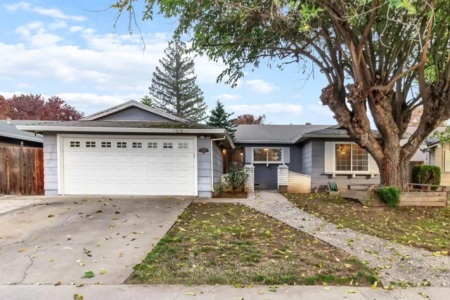 a front view of a house with a yard covered with snow