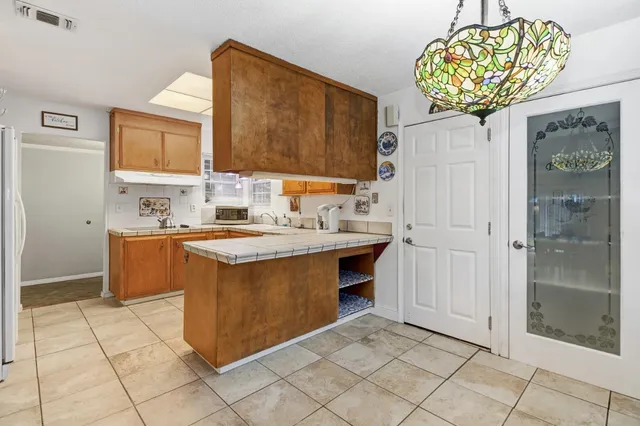 a kitchen with stainless steel appliances a sink and a refrigerator