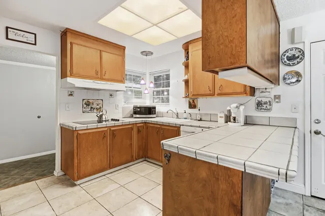 a kitchen with stainless steel appliances granite countertop a sink and a stove