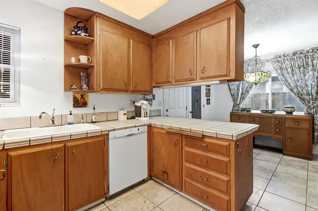 a kitchen that has a sink and a stove in it