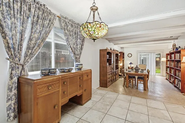 a dining room with furniture and a chandelier