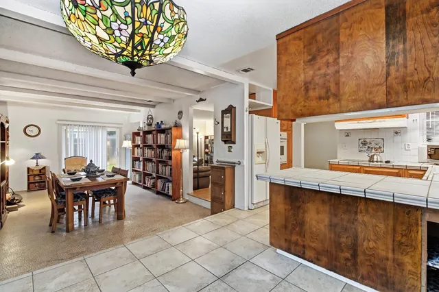 a dining room with a wooden table and chairs