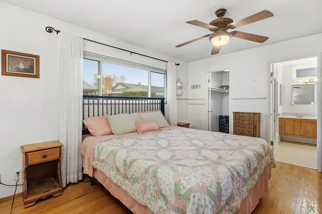 a bedroom with a large bed and a chandelier