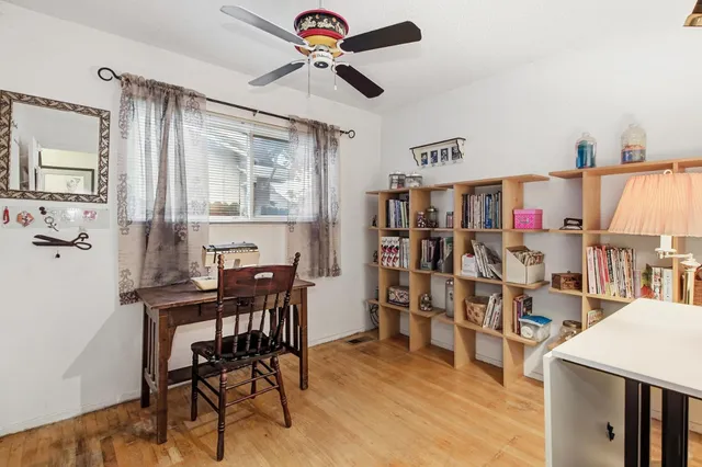 a view of a dining room with furniture and a chandelier fan