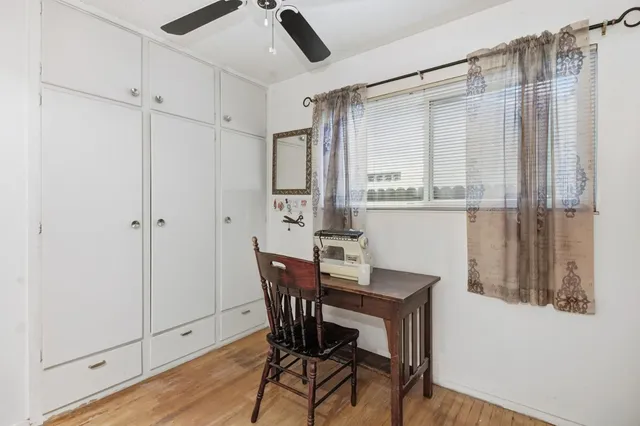 a view of a dining room with furniture and a window