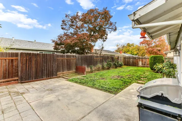 a view of a backyard with a garden and lake view