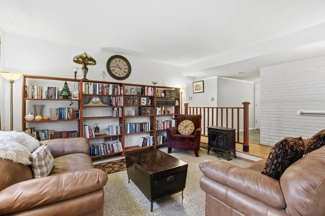 a living room with furniture a rug and a window