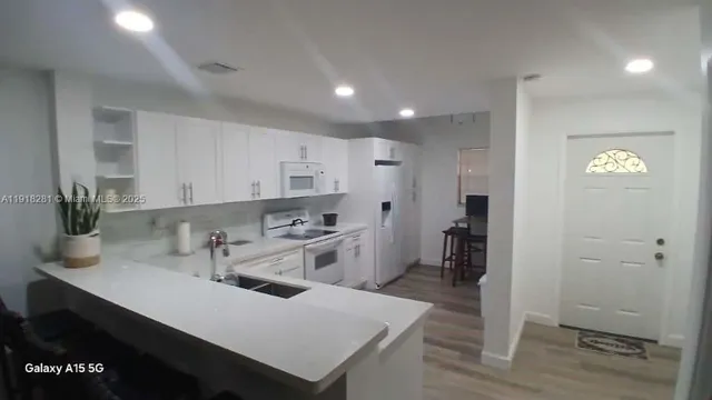 a spacious bathroom with a granite countertop sink a toilet and a mirror