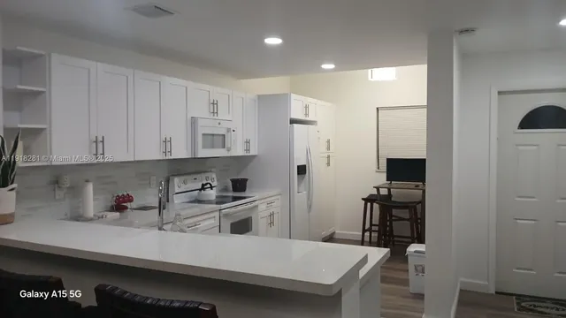 a kitchen with a sink cabinets and wooden floor