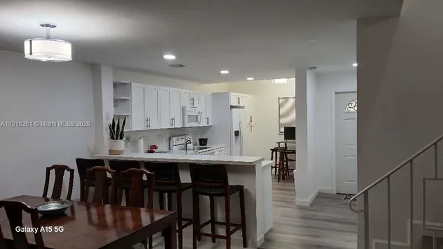 a bathroom with double vanity and a mirror