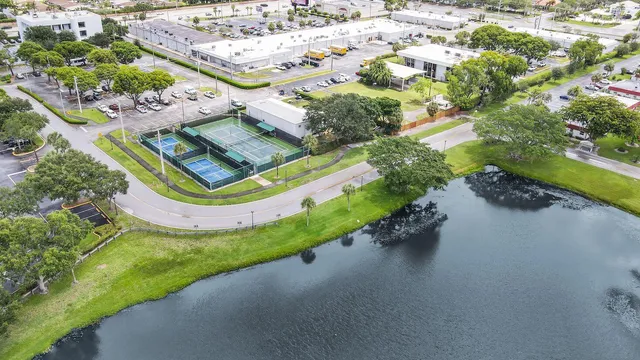an aerial view of a pool patio yard and lake view