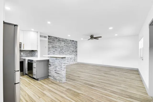 a view of kitchen with a sink cabinets and wooden floor