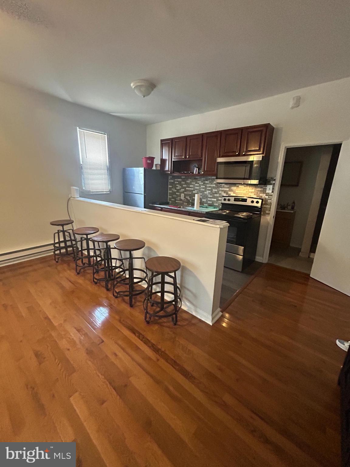 4100 Old York Road Philadelphia, PA 19140 - Photo 5 of 30 a kitchen with stainless steel appliances a dining table chairs and granite counter tops