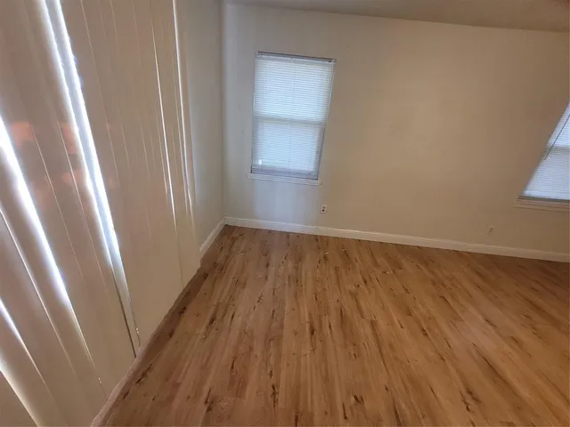 a view of a hallway in a house with wooden floor