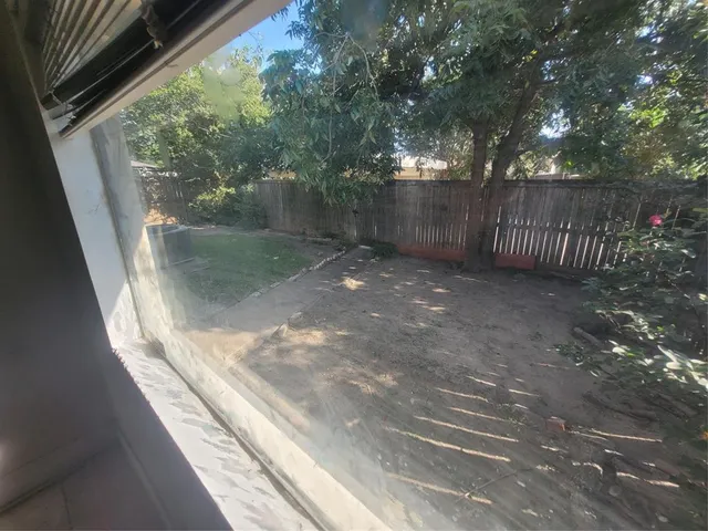 a view of a pathway of a house with a yard