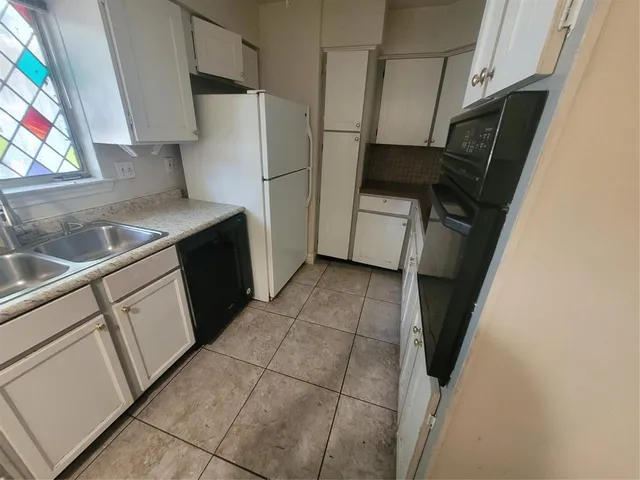 a kitchen with a refrigerator and a stove