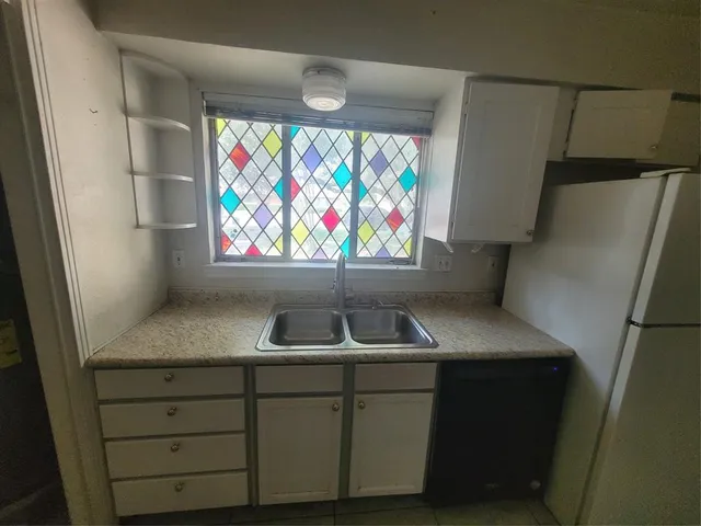 a kitchen with a sink and a refrigerator