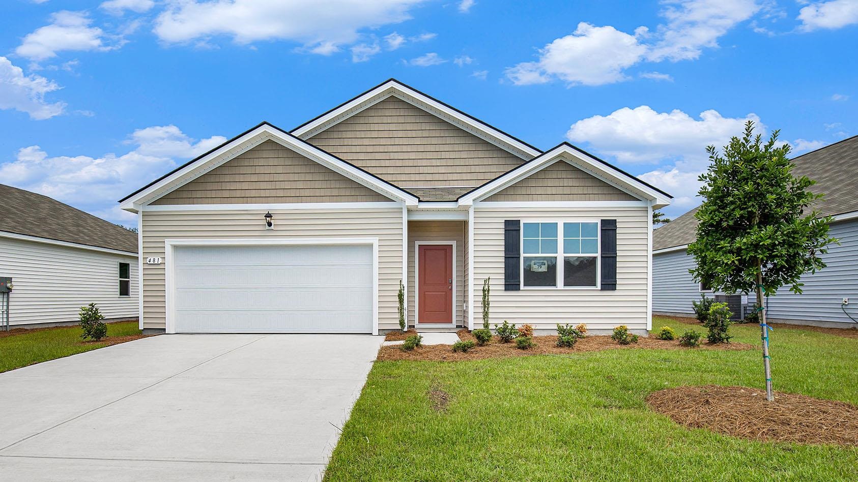 View of front of home featuring concrete driveway, a front yard, and an attached garage