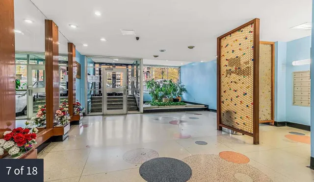 a lobby with furniture and flowers