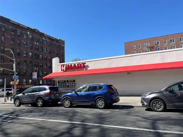 a view of a cars park in front of a building