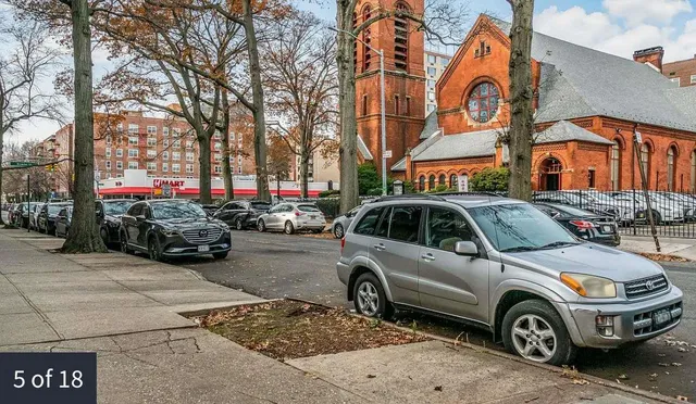 a front view of a building with parking space