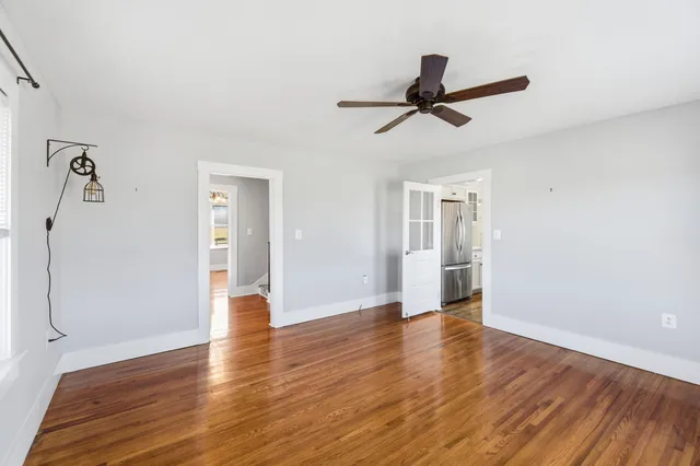 a view of a hallway with wooden floor and entryway