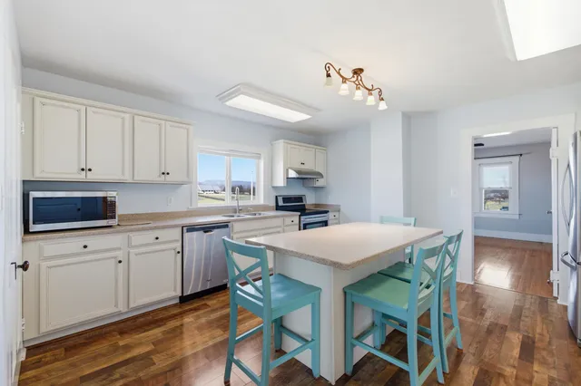 a kitchen that has a table and chairs in it