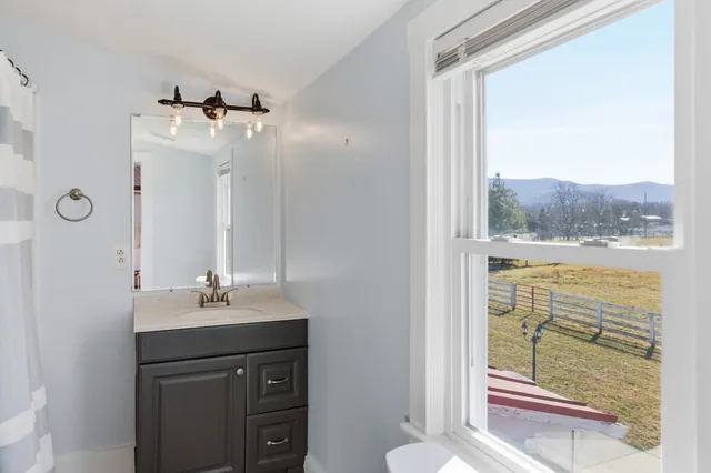 a bathroom with a sink a vanity and a window