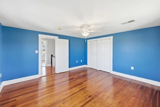 a view of a room with wooden floor