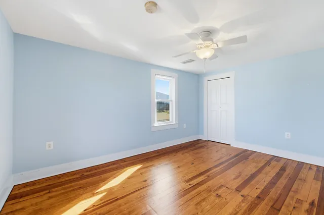 a view of a backyard with wooden fence