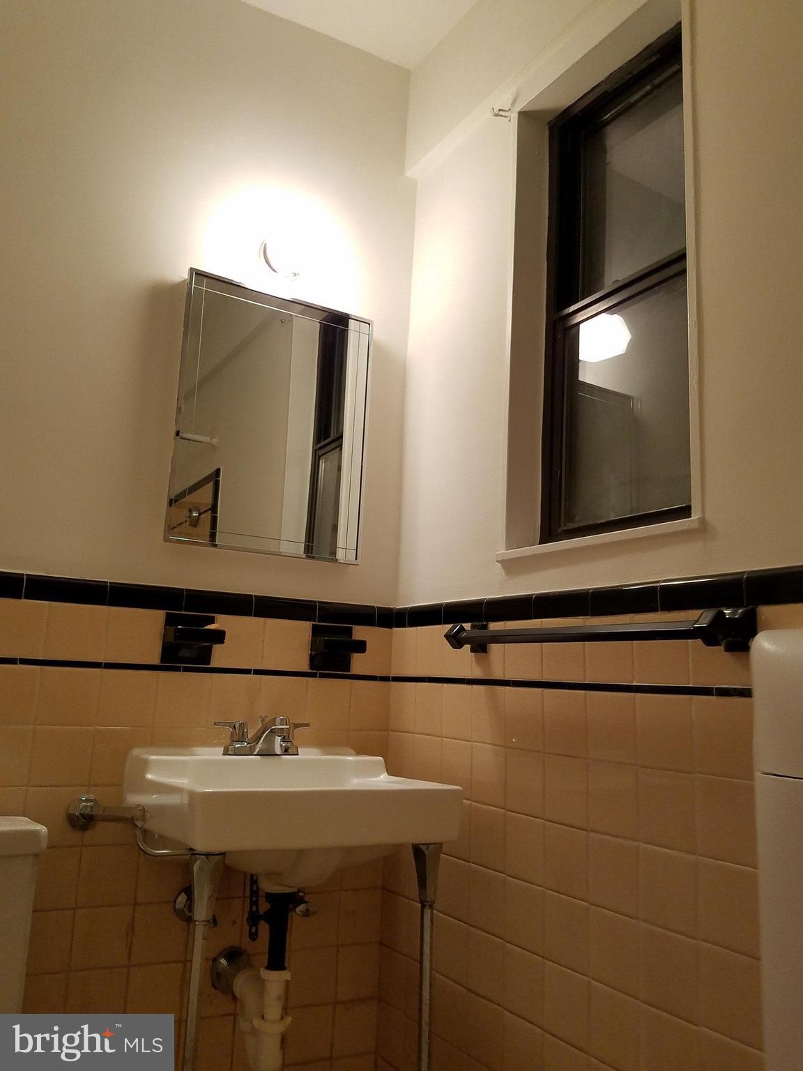 1 Scott Circle Northwest, Unit 102 Washington, DC 20005 - Photo 13 of 17 a bathroom with a sink and a mirror