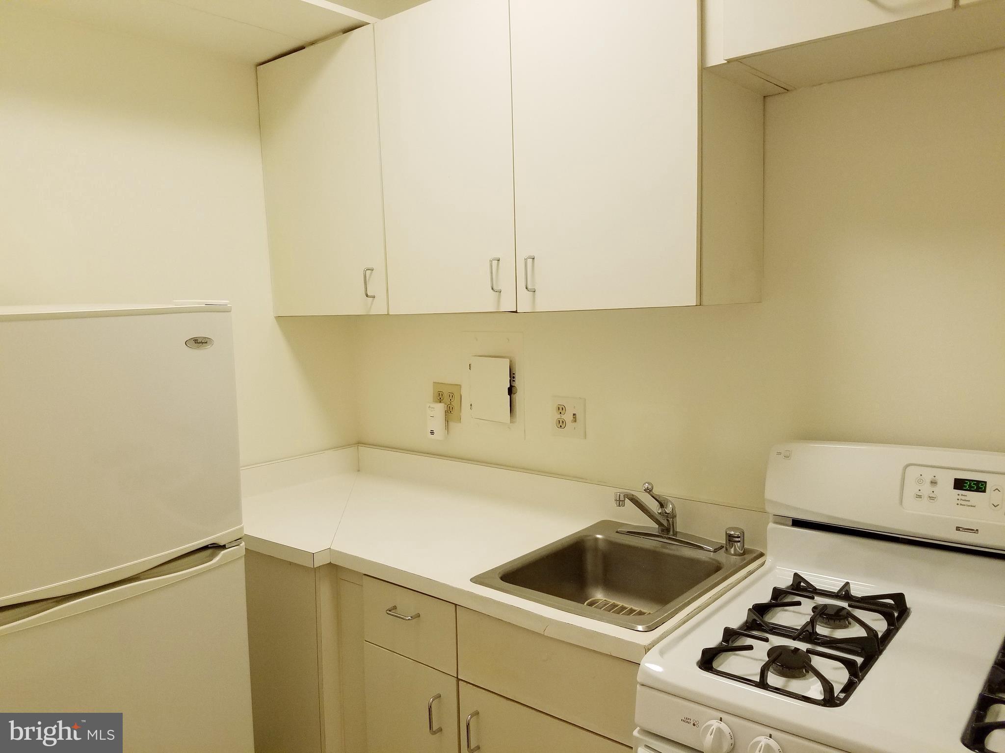1 Scott Circle Northwest, Unit 102 Washington, DC 20005 - Photo 17 of 17 a kitchen with a sink and a stove top oven