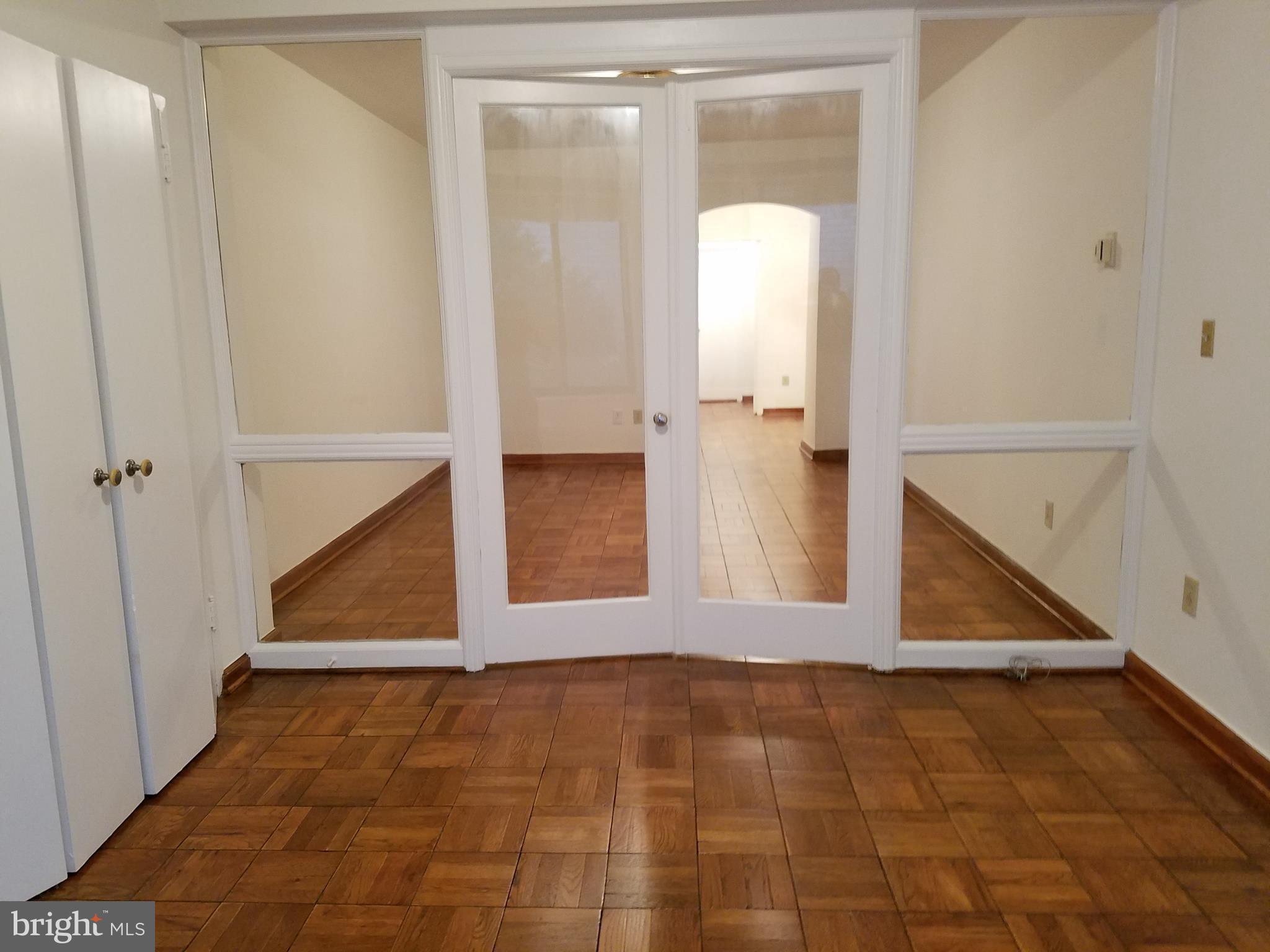 1 Scott Circle Northwest, Unit 102 Washington, DC 20005 - Photo 6 of 17 an empty room with an entryway and door