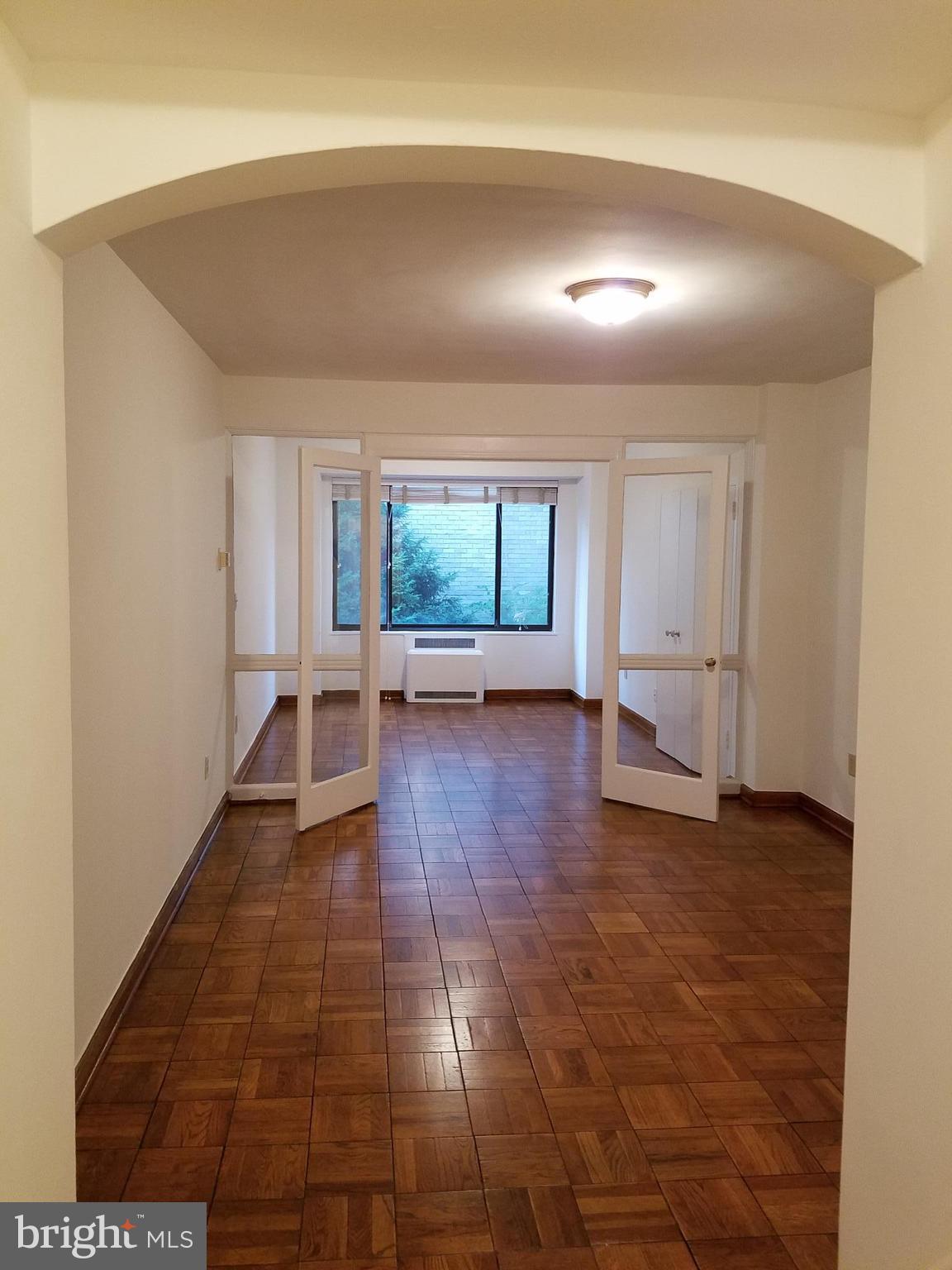 1 Scott Circle Northwest, Unit 102 Washington, DC 20005 - Photo 9 of 17 a view of a big room with wooden floor and windows