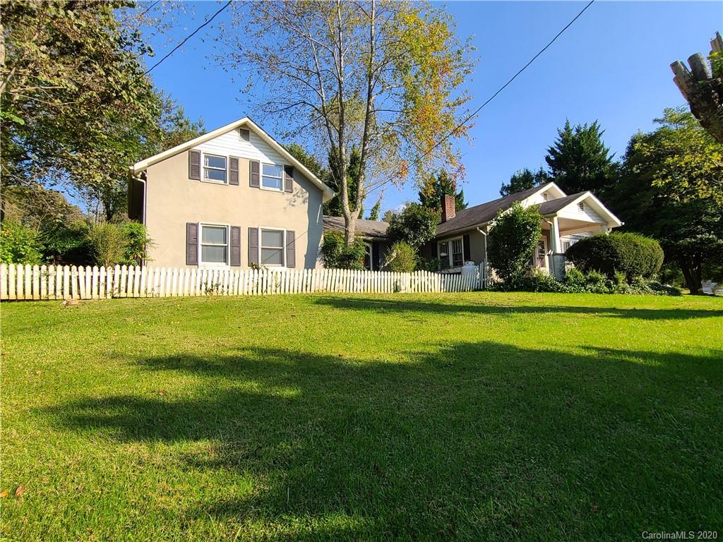 26 Jones Road Leicester, NC 28748 - Photo 1 of 34 a front view of a house with a garden and yard