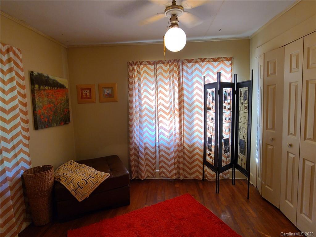 26 Jones Road Leicester, NC 28748 - Photo 14 of 34 a view of an empty room with wooden floor and a window