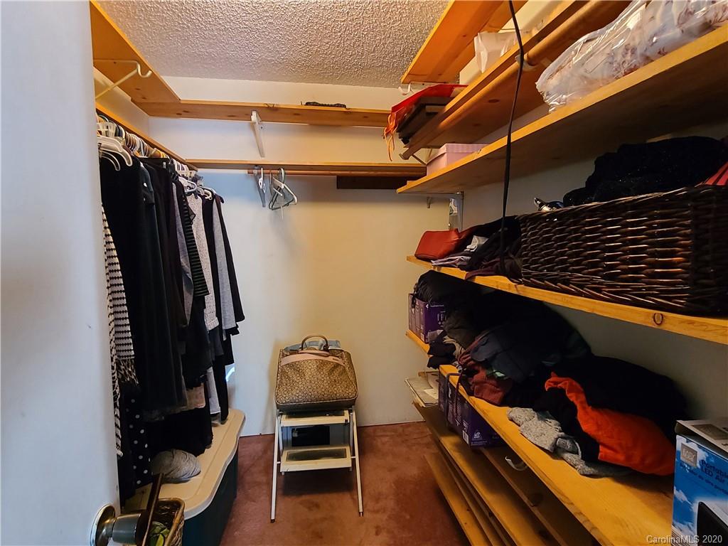26 Jones Road Leicester, NC 28748 - Photo 21 of 34 a view of walk in closet with clothes and shoes
