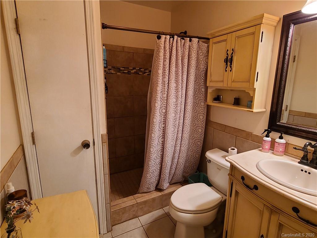 26 Jones Road Leicester, NC 28748 - Photo 22 of 34 a bathroom with a sink toilet and shower