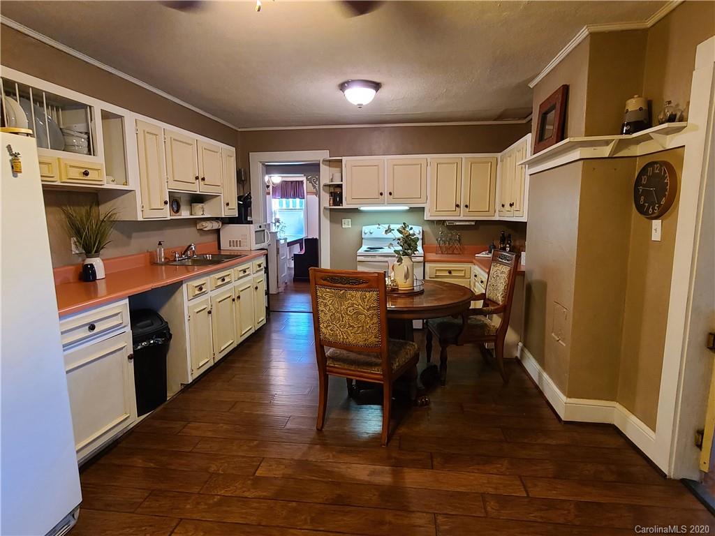 26 Jones Road Leicester, NC 28748 - Photo 6 of 34 a kitchen with stainless steel appliances granite countertop a refrigerator a sink dishwasher a stove with wooden cabinets and floor