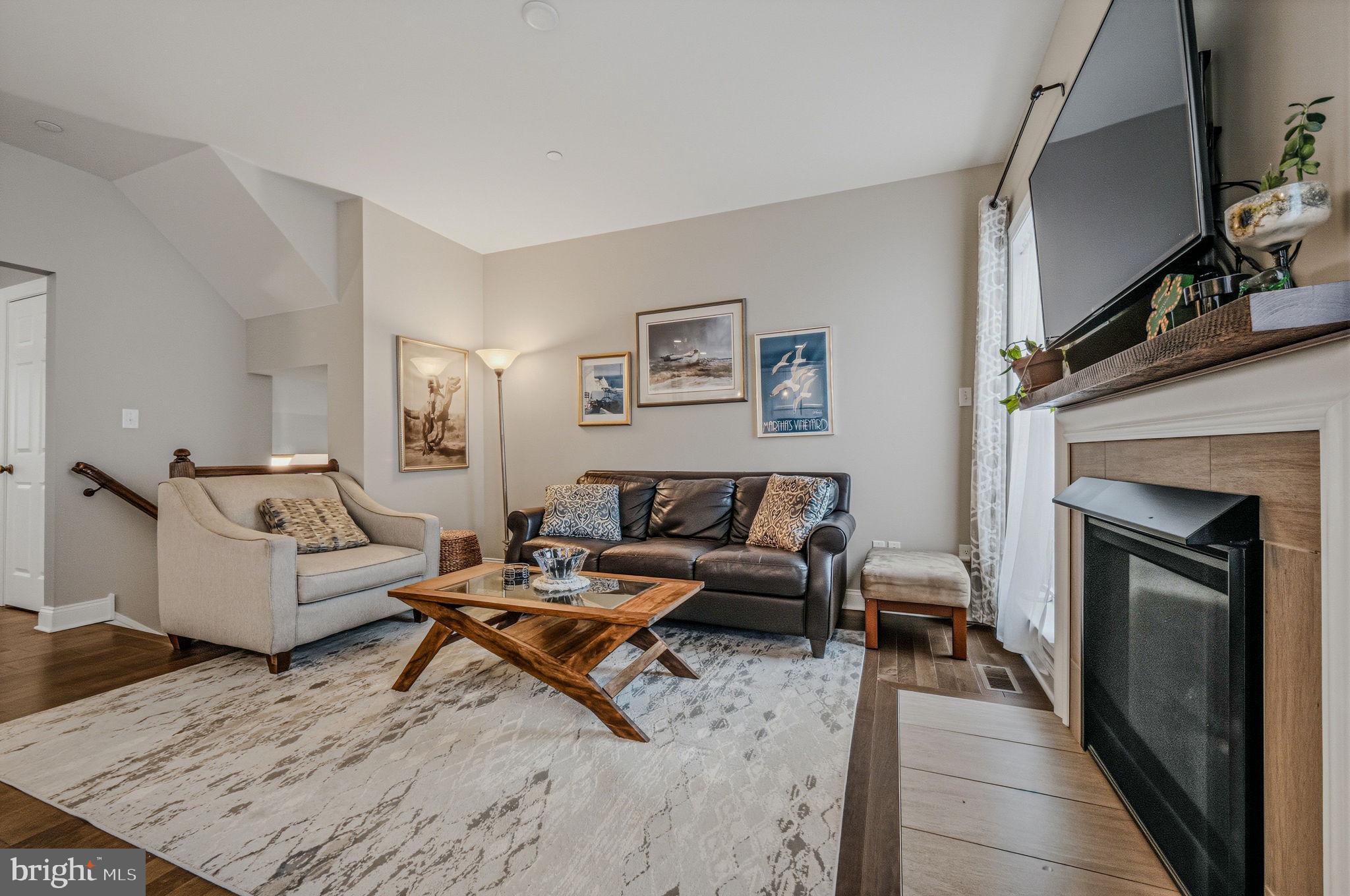 208 Jackdaw Alley, Unit 208 Springfield, PA 19064 - Photo 11 of 43 a living room with furniture and a fireplace