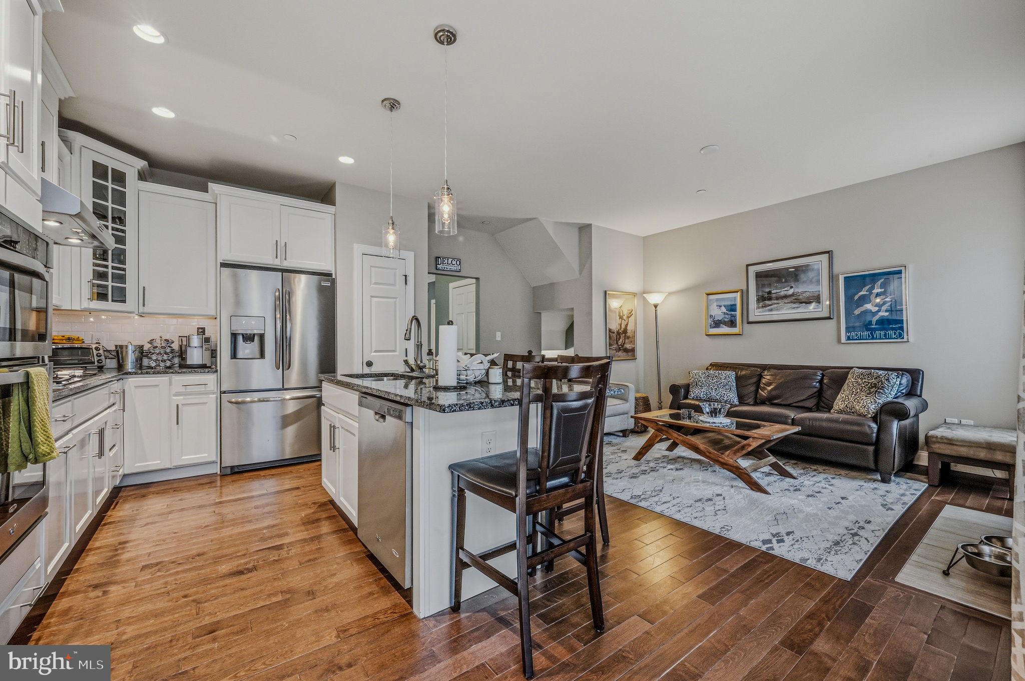 208 Jackdaw Alley, Unit 208 Springfield, PA 19064 - Photo 15 of 43 a kitchen with refrigerator cabinets and wooden floor