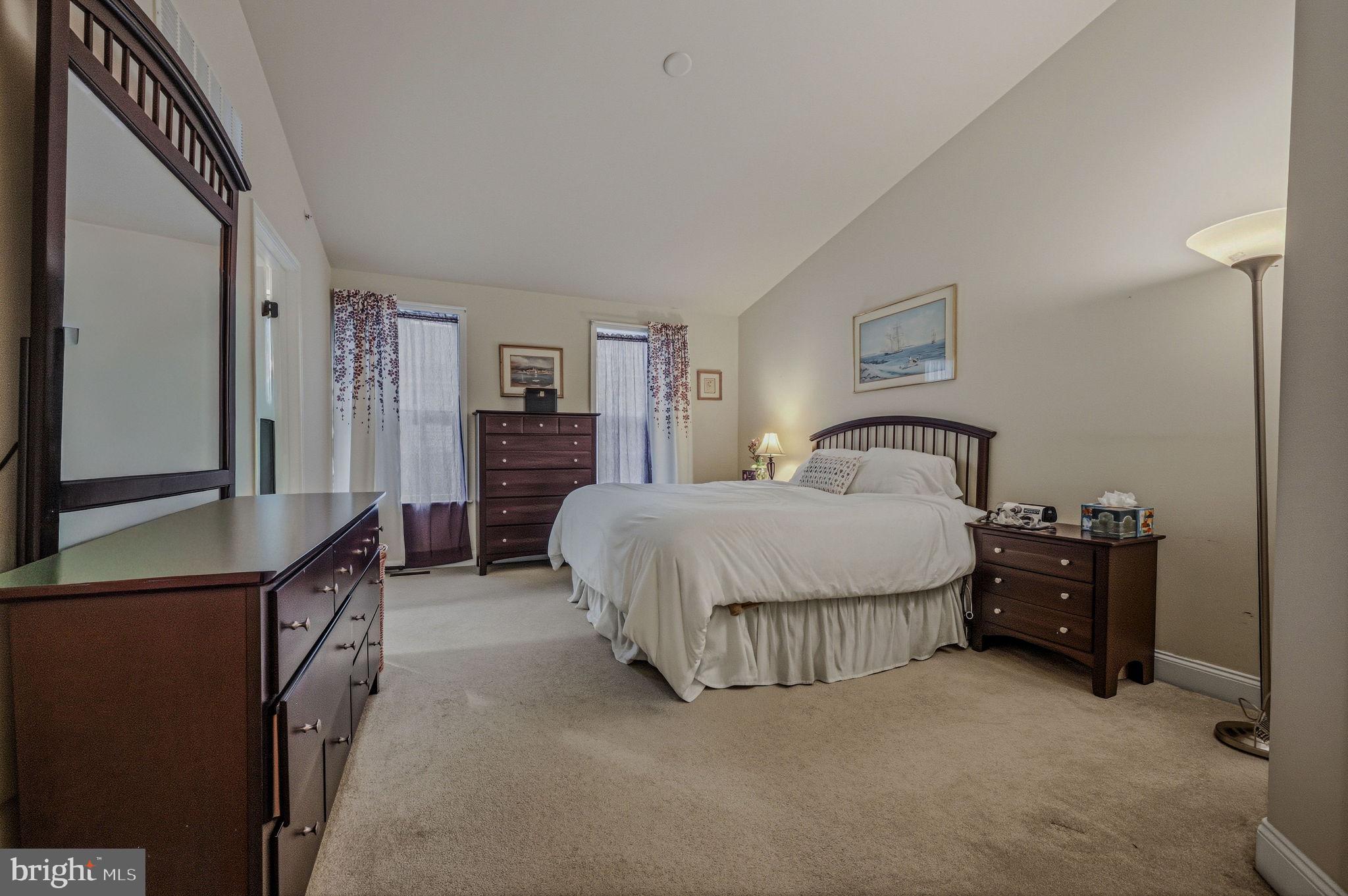 208 Jackdaw Alley, Unit 208 Springfield, PA 19064 - Photo 16 of 41 a spacious bedroom with a bed and a dresser