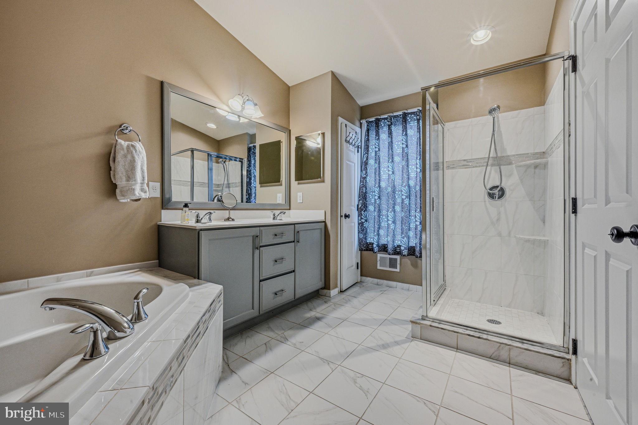 208 Jackdaw Alley, Unit 208 Springfield, PA 19064 - Photo 19 of 41 a bathroom with a tub sink and mirror